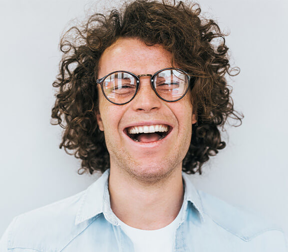 man with glasses laughing