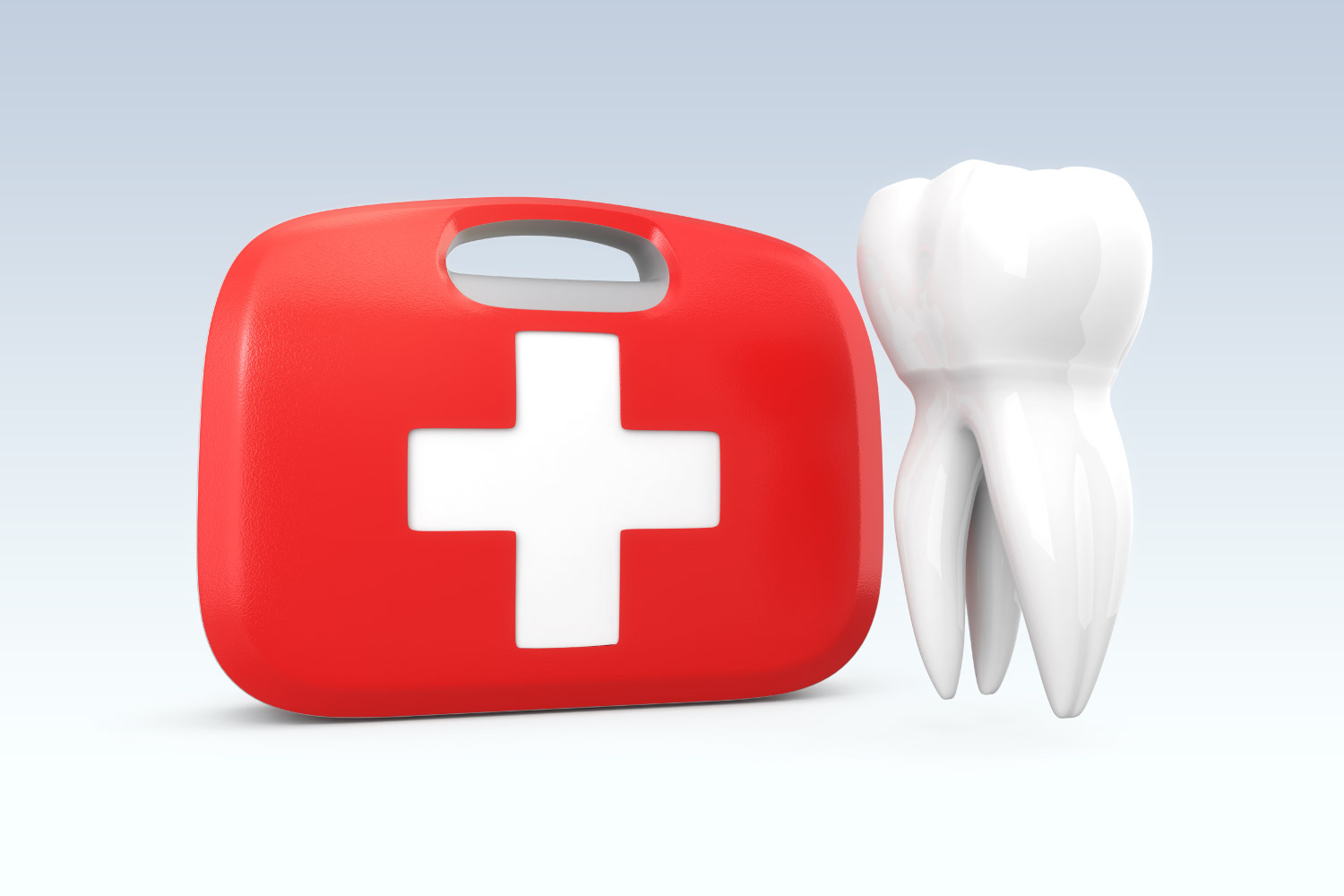 Tooth next to a red and white first aid kit to treat a dental emergency in Dallas, TX